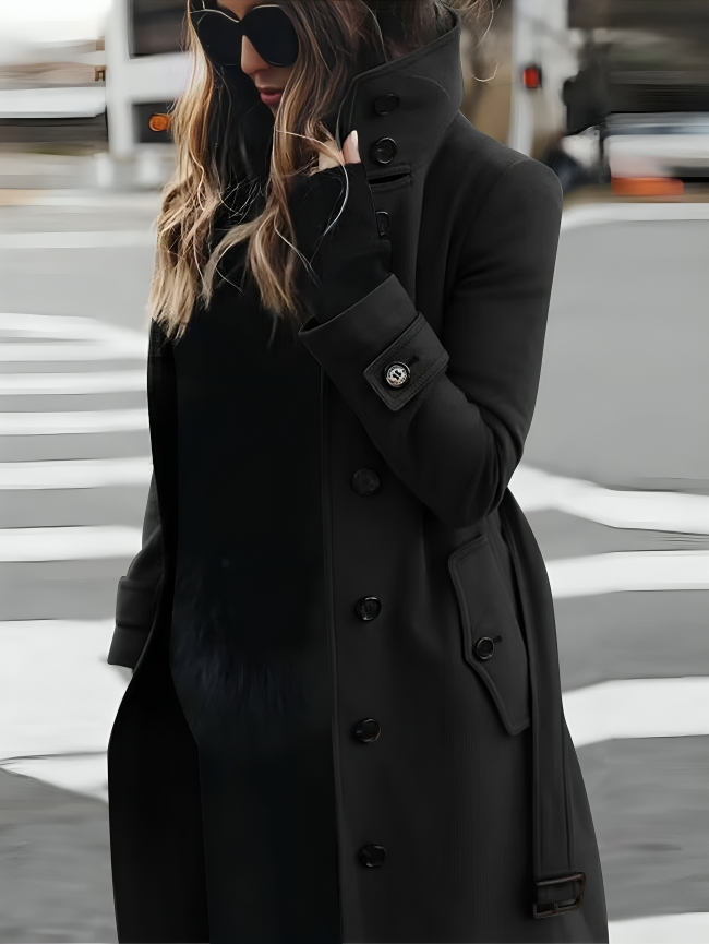 Stylish long women's coat with a high collar and elegant bow belt